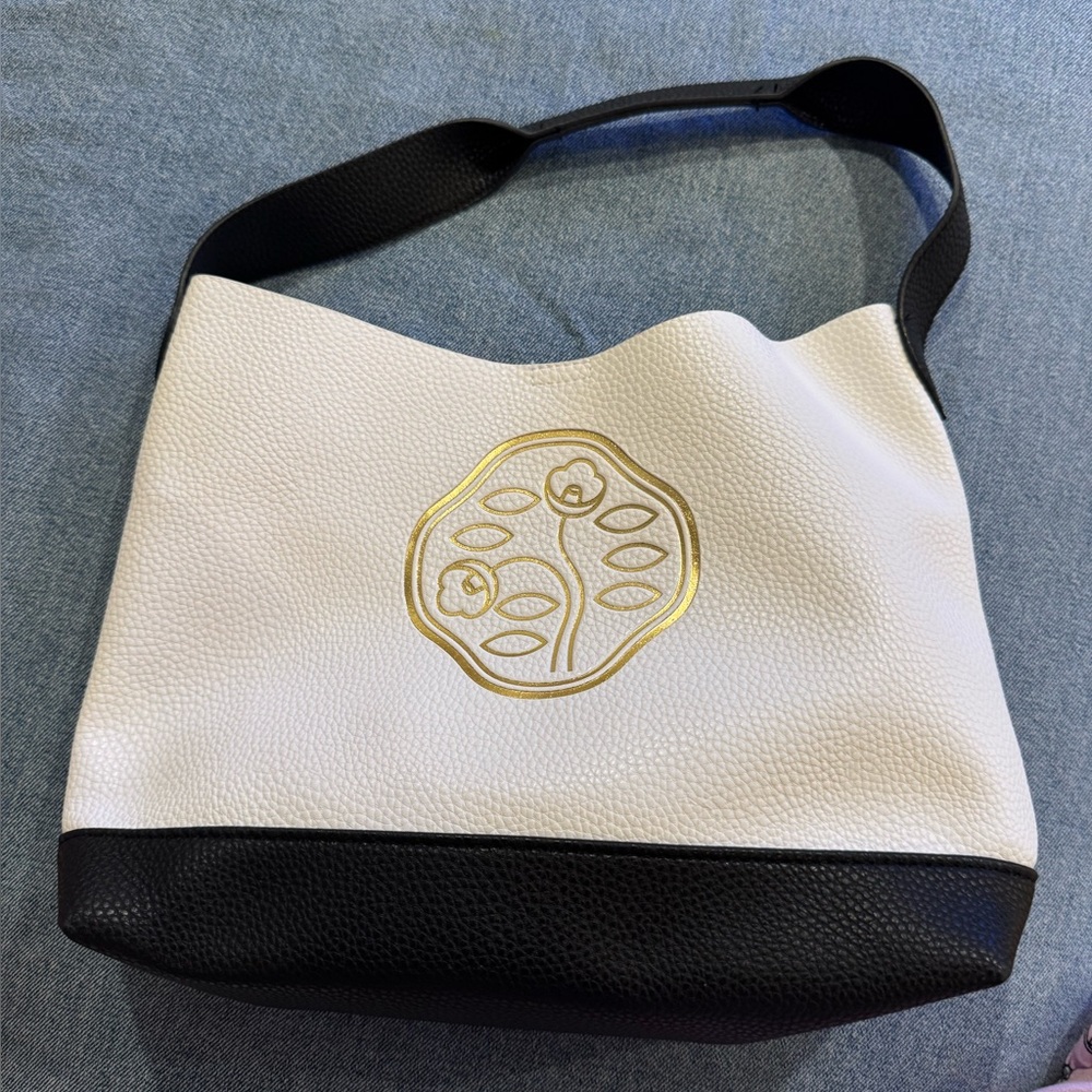 New Cle de peau small white and black with a gold emblem bag
